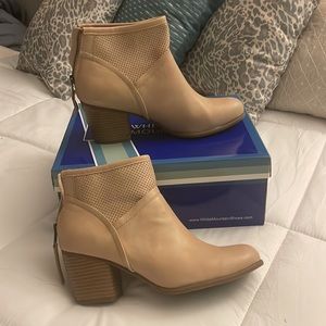 Cream colored ankle boots with a chunky heel